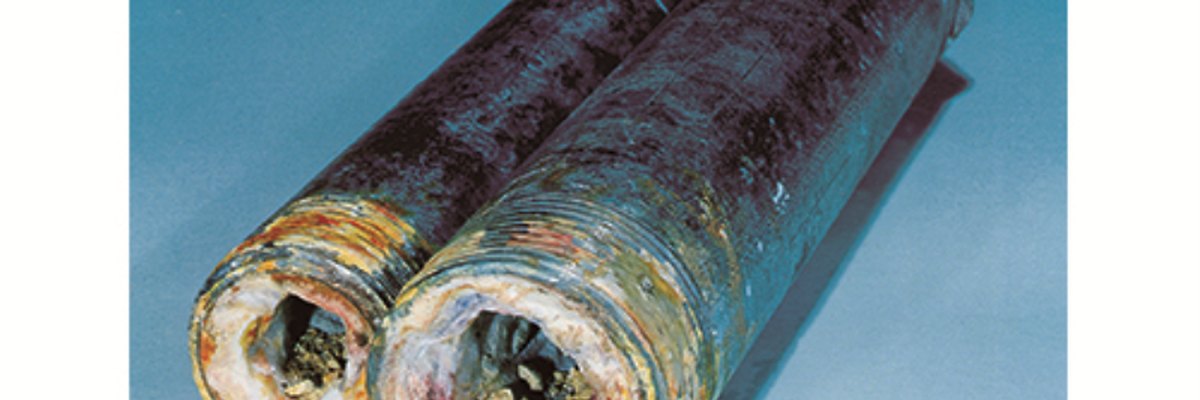 Corroded pipes showing scale and blue-green buildup